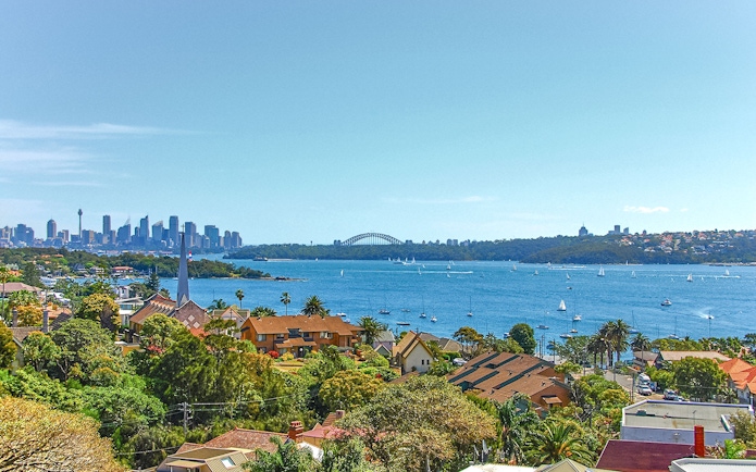 Watson's Bay view of Sydney Harbour with city skyline and sailboats.