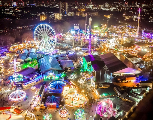 Hyde Park Winter Wonderland entrance with festive lights and attractions in London.