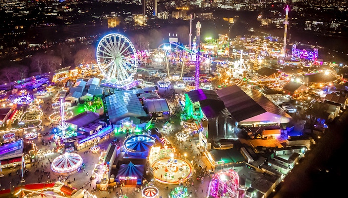 Hyde Park Winter Wonderland entrance with festive lights and attractions in London.