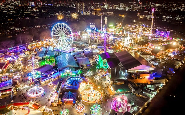Hyde Park Winter Wonderland entrance with festive lights and attractions in London.