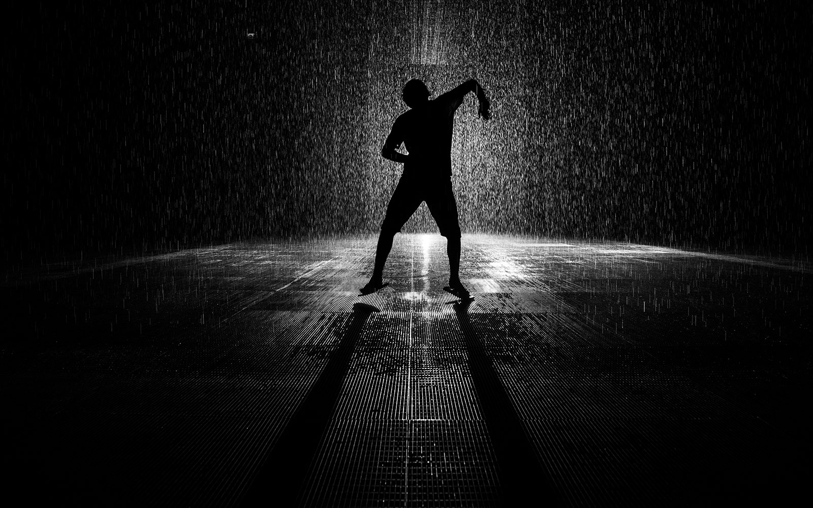 Man dancing in Sharjah Rain Room installation.