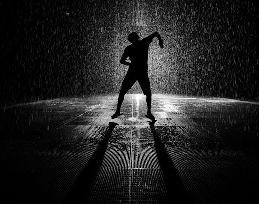 Man dancing in Sharjah Rain Room installation.