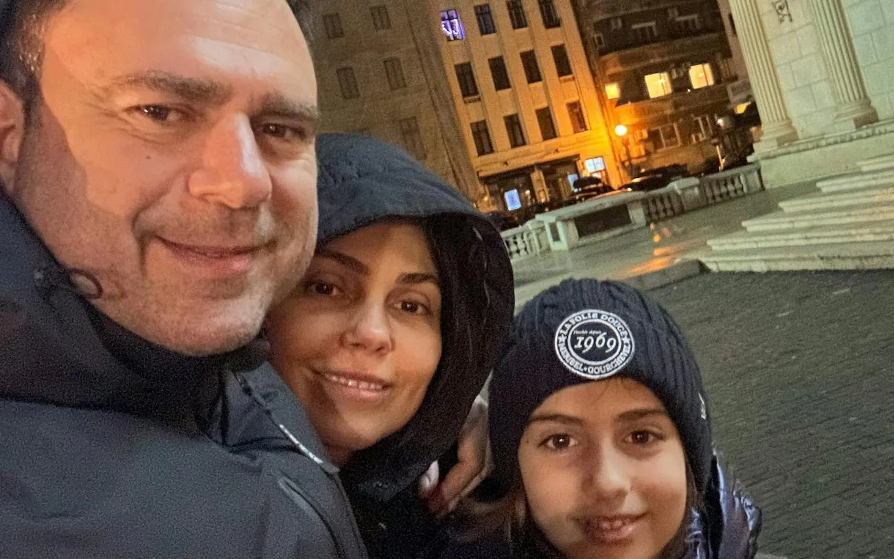 Family exploring Bucharest at night during the Road of Gold Mystery city game.