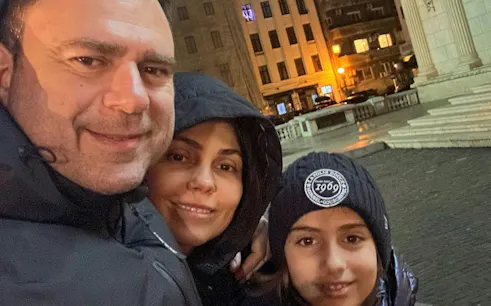 Family exploring Bucharest at night during the Road of Gold Mystery city game.