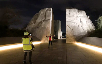 Tourists photographing at the Martin Luther King Memorial at night, Washington D.C.