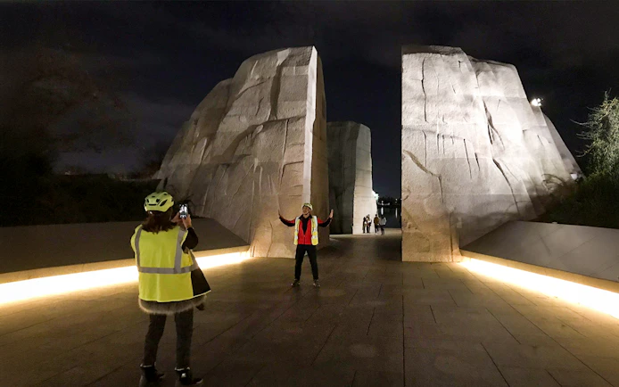 Tourists photographing at the Martin Luther King Memorial at night, Washington D.C.