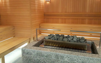Sauna interior at Pesterzsebet Bath, Budapest with wooden benches and stone heater.