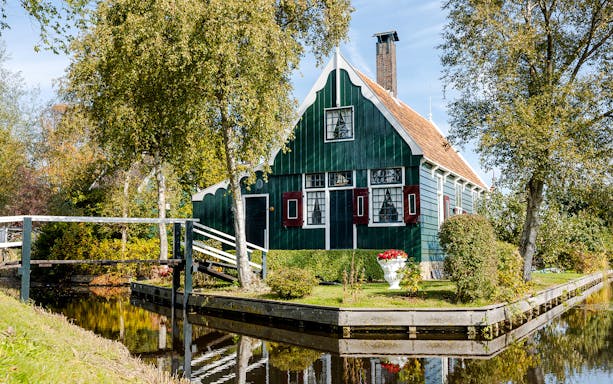 Traditional Dutch house by a canal at Zaanse Schans, Netherlands.