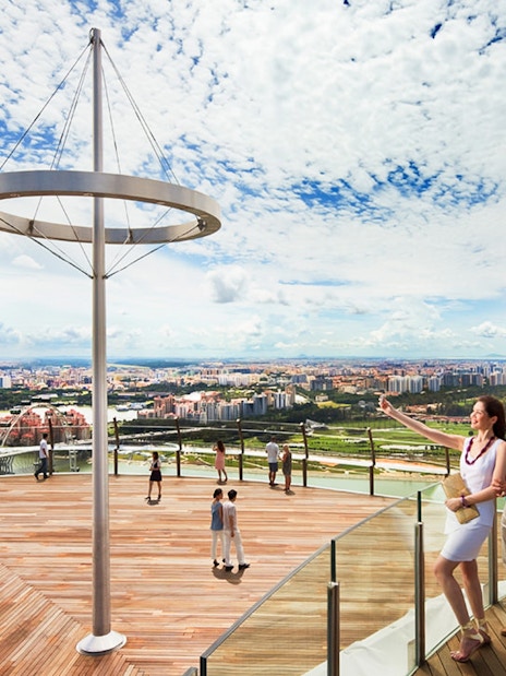 Visitors enjoying the view from Marina Bay Sands SkyPark Observation Deck, Singapore.