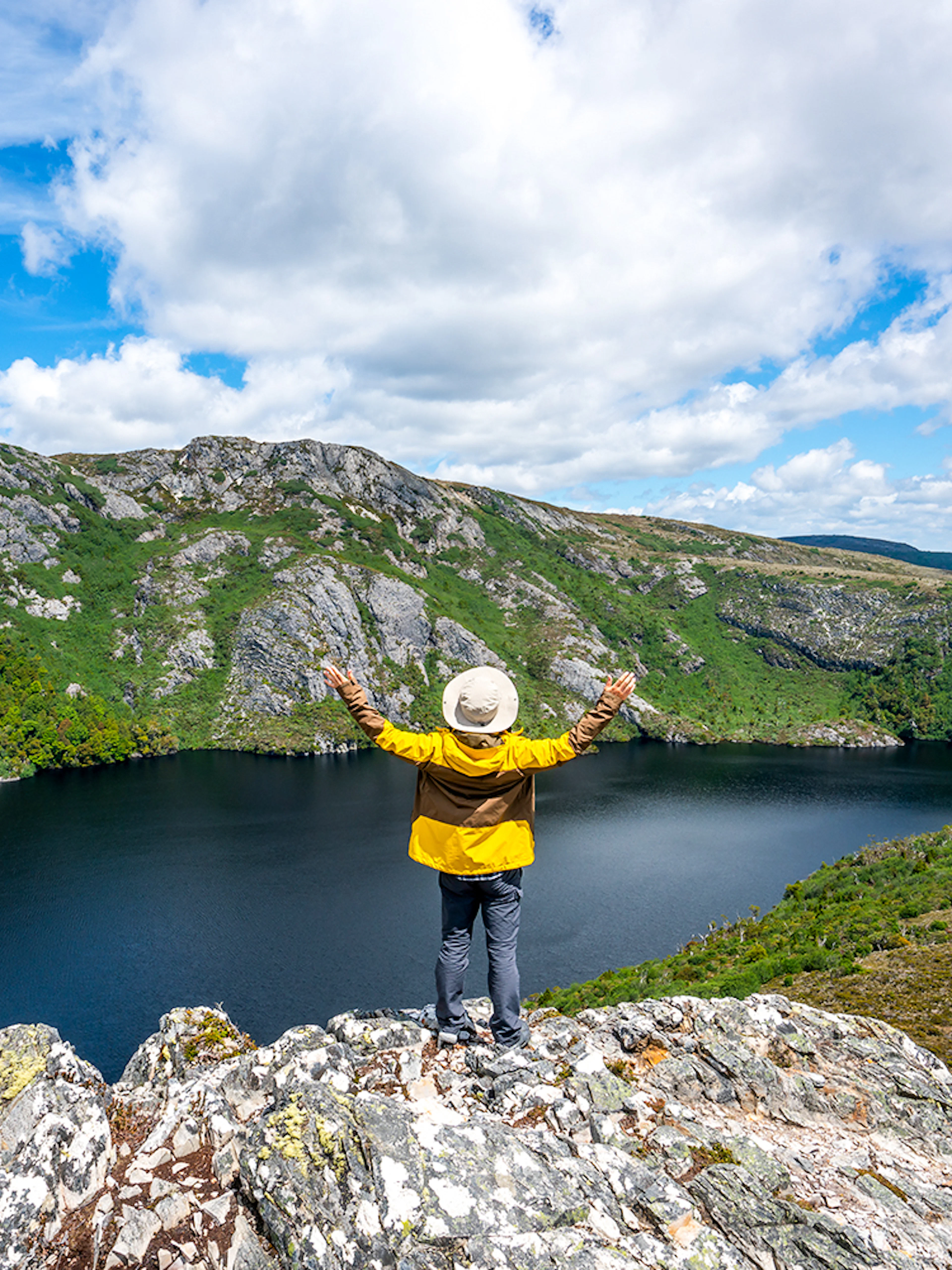 Person overlooking Dove Lake and Cradle Mountain landscape in Tasmania.
