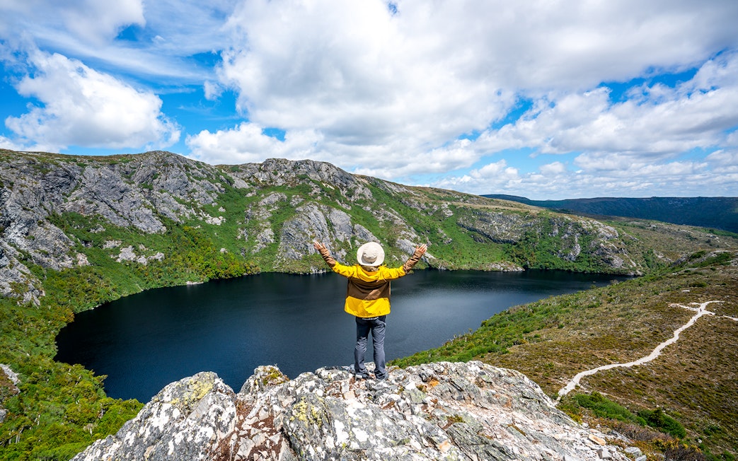 Person overlooking Dove Lake and Cradle Mountain landscape in Tasmania.