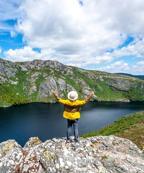 Person overlooking Dove Lake and Cradle Mountain landscape in Tasmania.