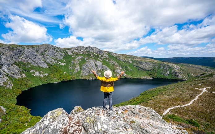 Person overlooking Dove Lake and Cradle Mountain landscape in Tasmania.