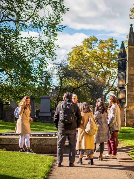 Group on a guided Harry Potter walking tour in a historic cemetery.