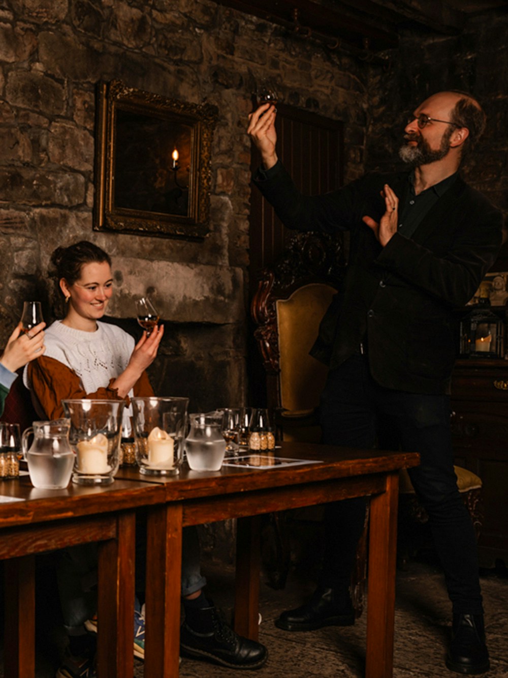 Guests enjoying whisky tasting at an underground tour in Edinburgh.