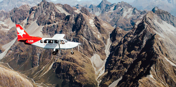 Scenic flyover of Milford Sound mountains from Queenstown with Glenorchy Air plane.