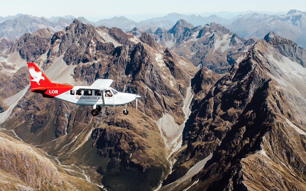 Scenic flyover of Milford Sound mountains from Queenstown with Glenorchy Air plane.