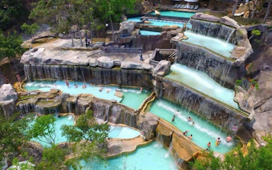 Tiered rock pools with waterfalls at Cai River View, Dubai.