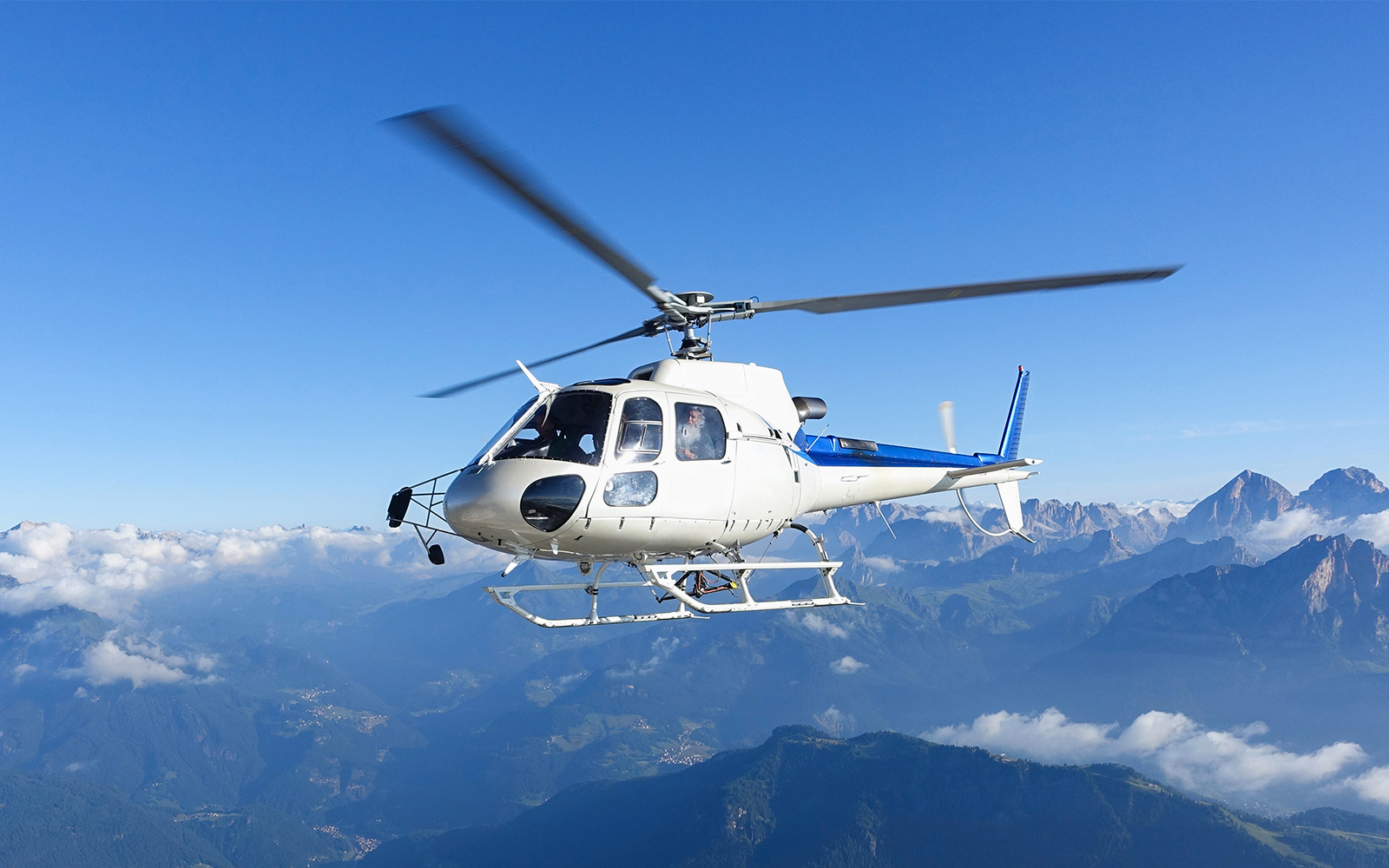 Helicopter flying over the Matterhorn with mountain views.