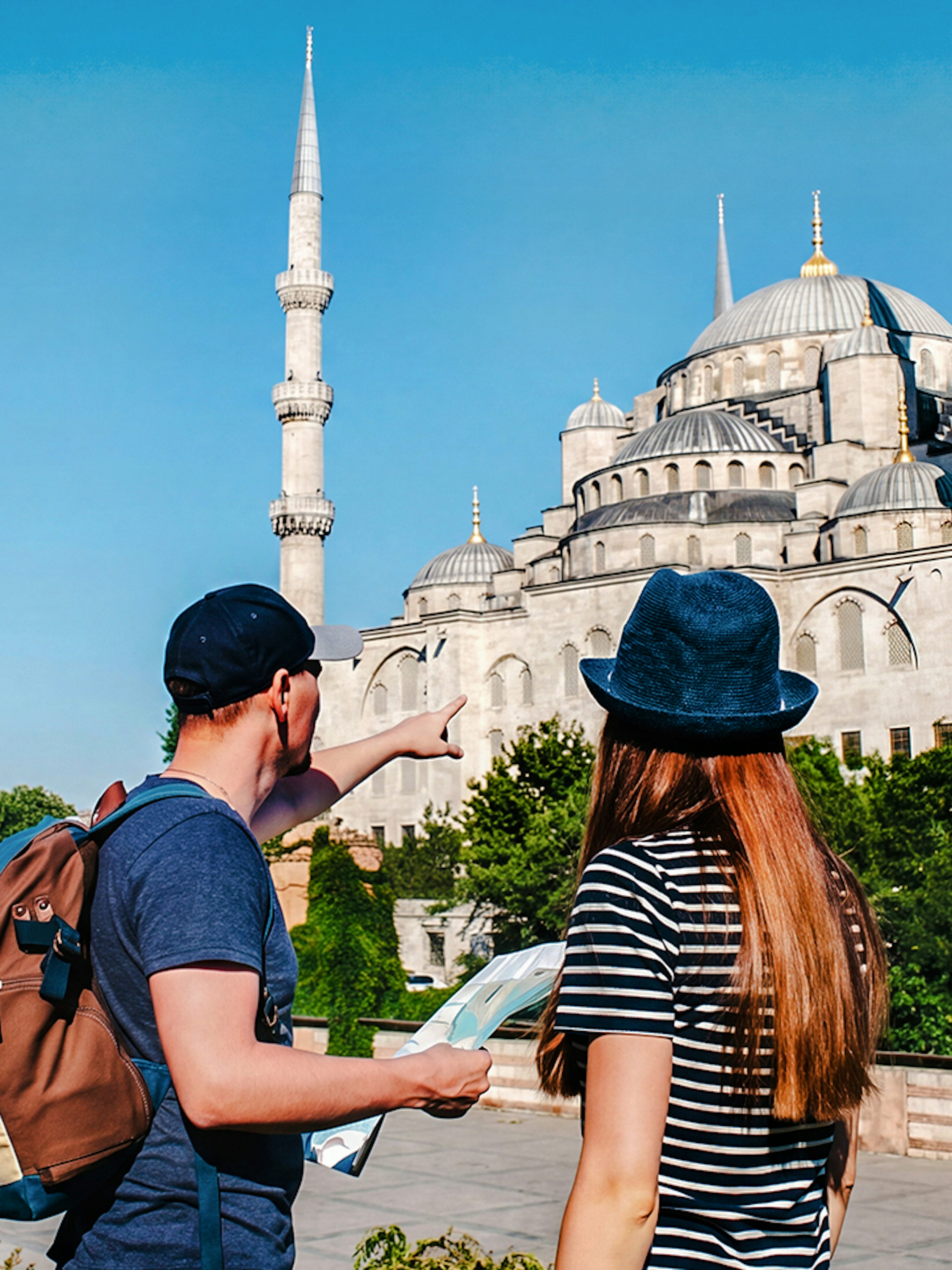 Guide and tourist with map near Blue Mosque, Istanbul.
