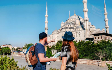 Guide and tourist with map near Blue Mosque, Istanbul.