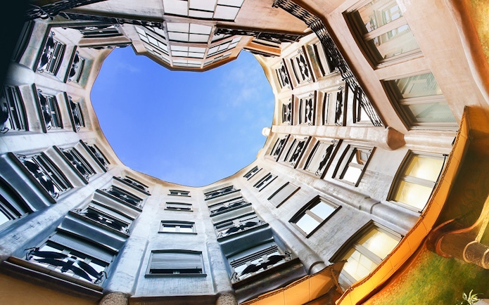 Casa Milà courtyard view with blue sky, Barcelona.