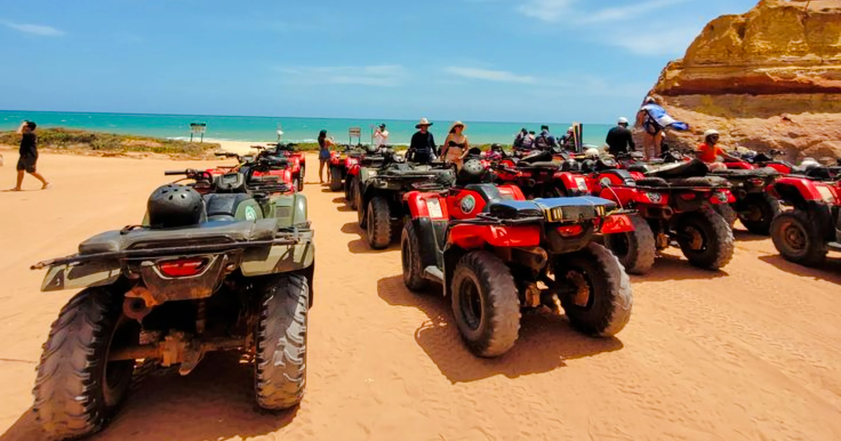 ATVs lined up on a sandy beach during a multi-day Morocco road trip from Essaouira.