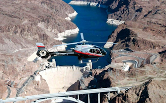 Helicopter flying over Hoover Dam en route to Grand Canyon West.