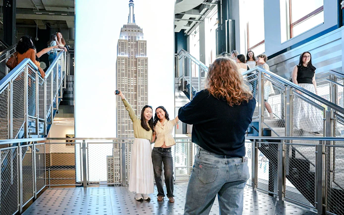 Visitors posing for a photo inside the Empire State Building, New York City.
