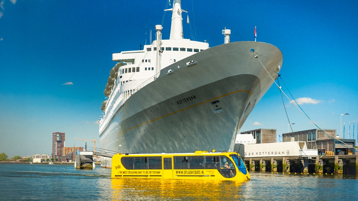 Yellow amphibious bus near SS Rotterdam during 1-hour sightseeing splash tour.
