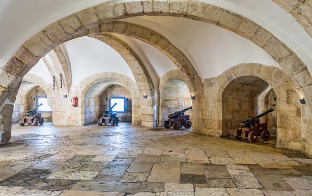 Cannons in stone arches inside Belem Tower, Lisbon.