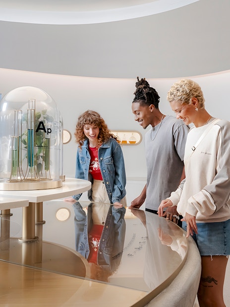 Friends exploring interactive exhibit at World of Coca-Cola Museum, Atlanta.