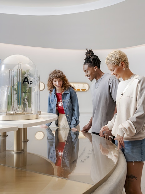 Friends exploring interactive exhibit at World of Coca-Cola Museum, Atlanta.