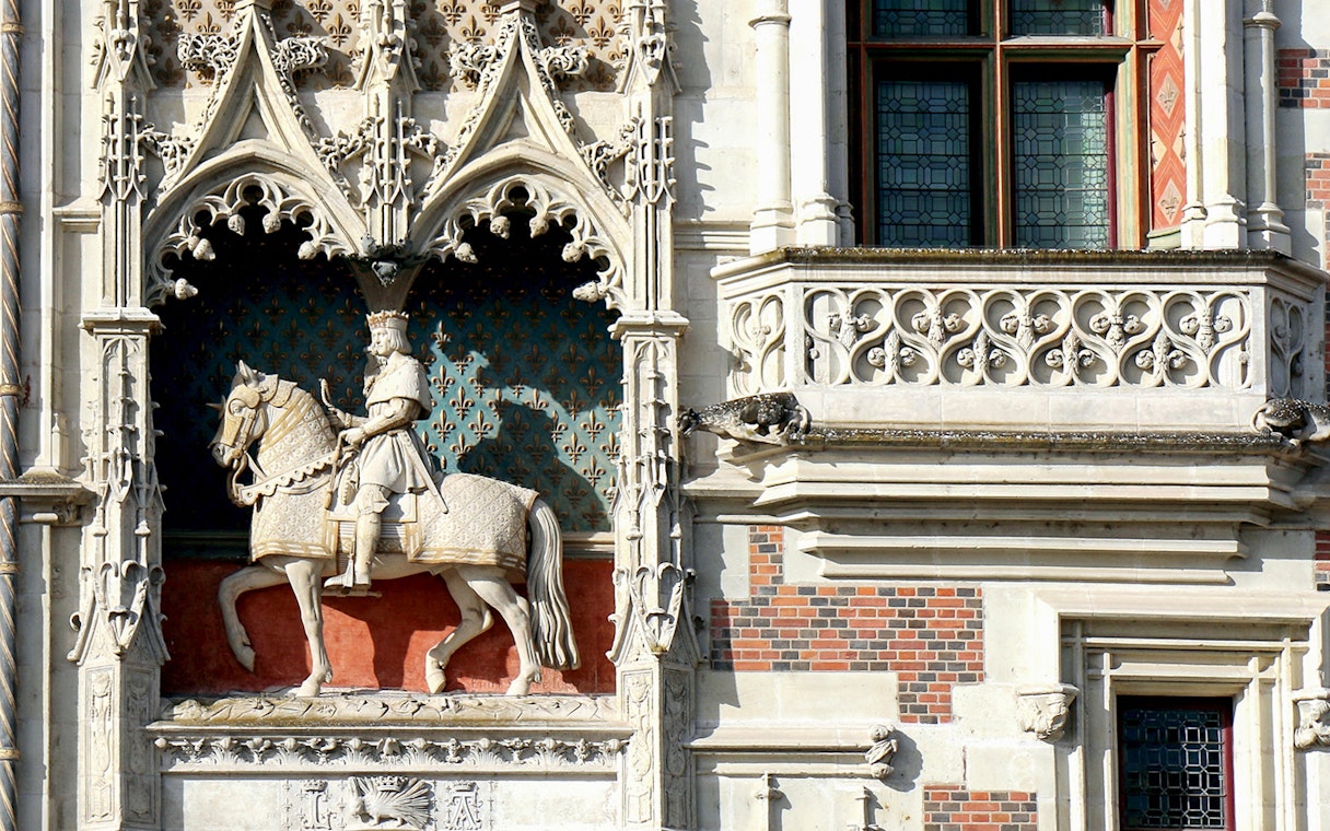 Stone statue of a knight on horseback at Blois Castle, France.