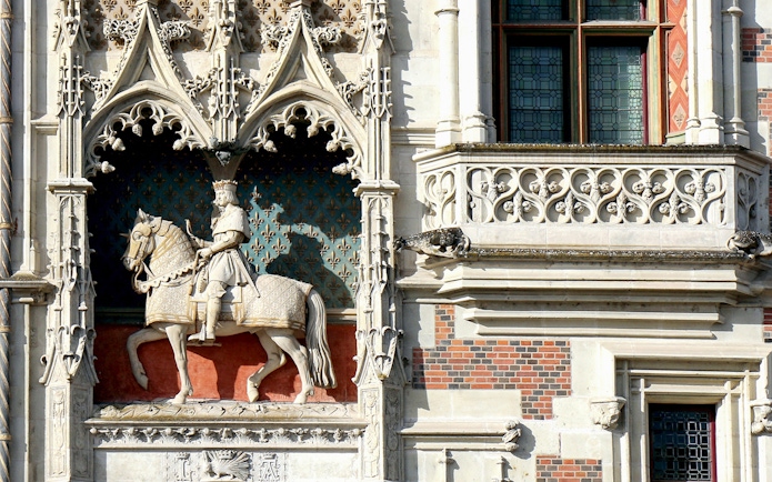 Stone statue of a knight on horseback at Blois Castle, France.