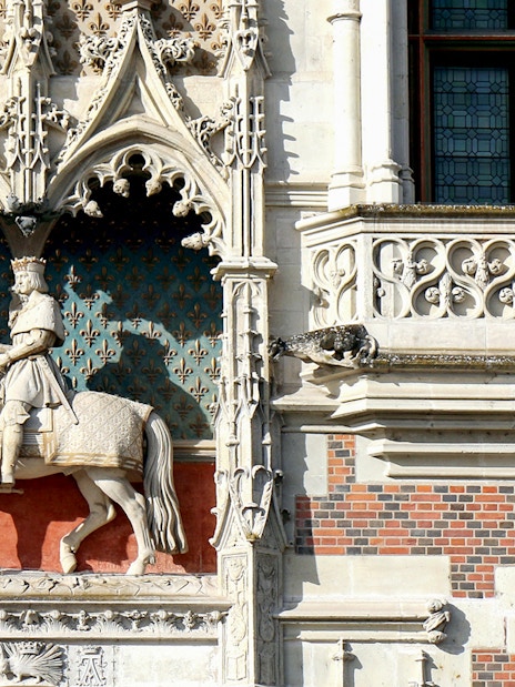 Stone statue of a knight on horseback at Blois Castle, France.