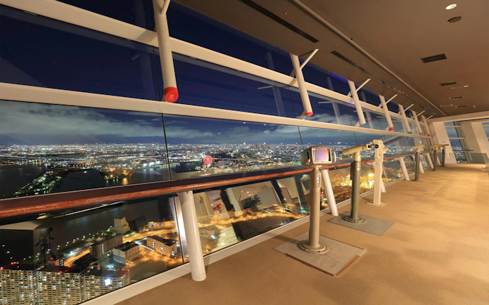 Osaka Sakishima Observatory interior with city skyline view at night.