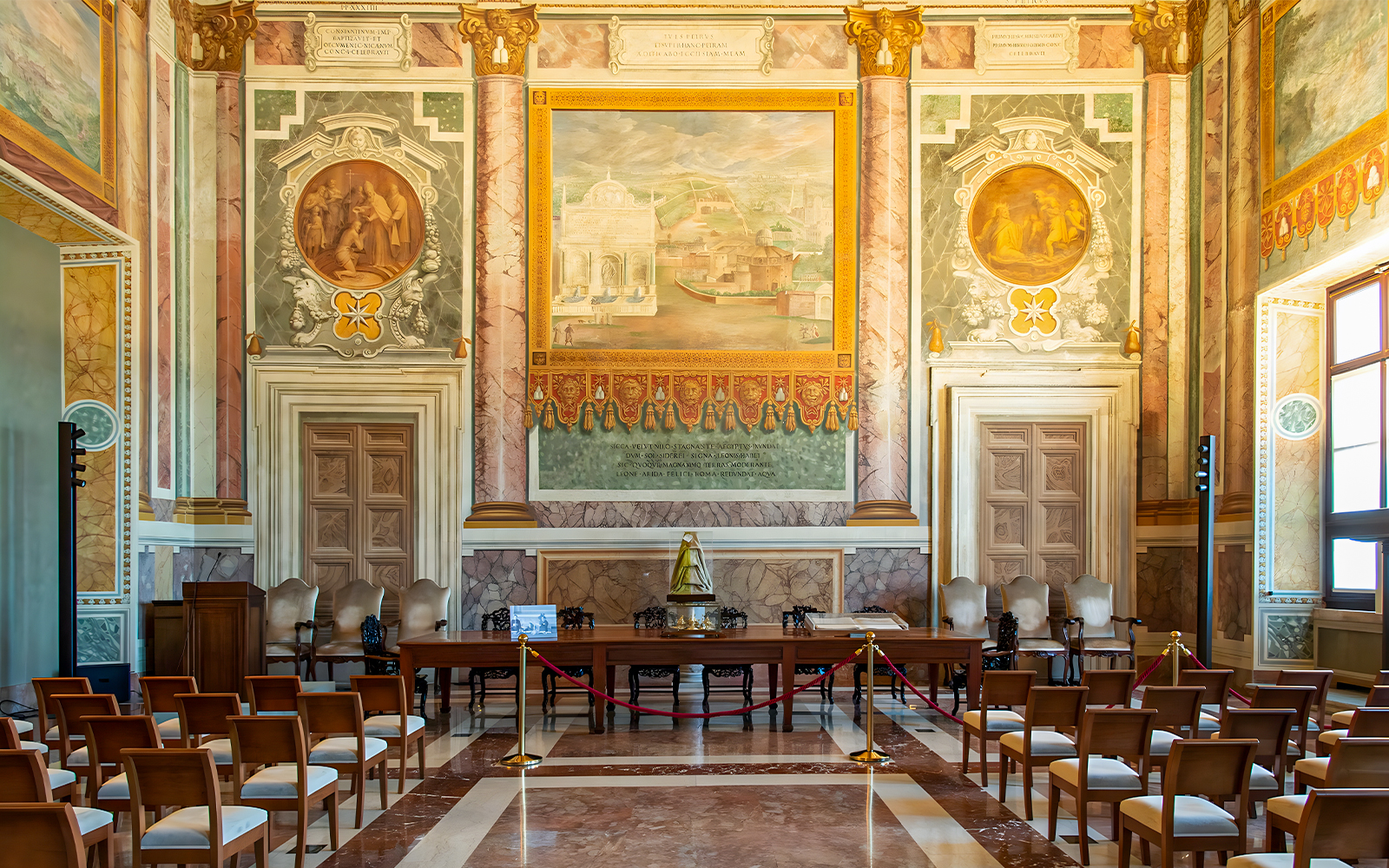 Interior of St. John Lateran with ornate frescoes and seating area for audio guide tour.