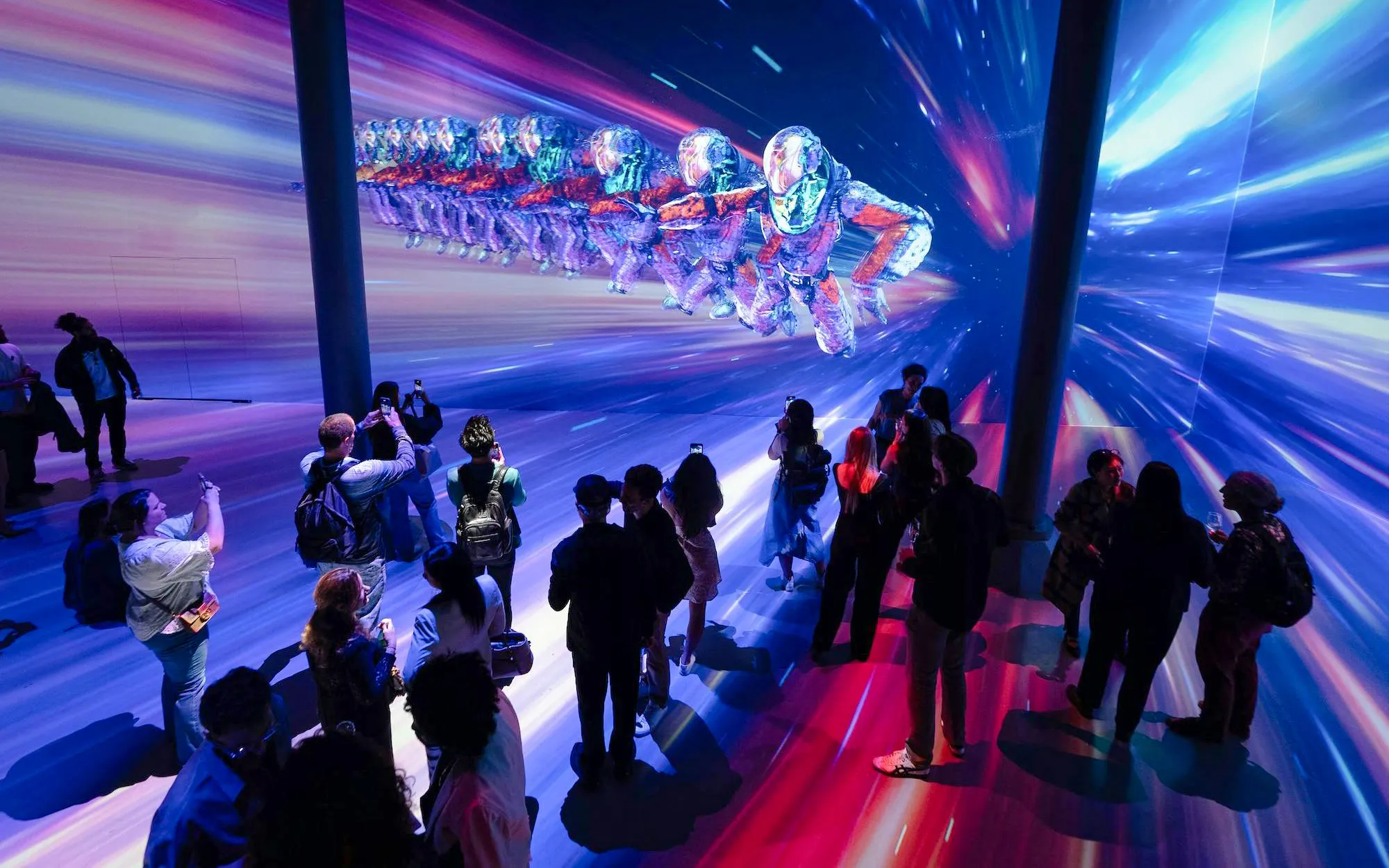 Guests viewing digital art installation at ARTECHOUSE DC exhibit.