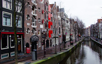 Canal-side buildings in Amsterdam's Red Light District during a guided walking tour.