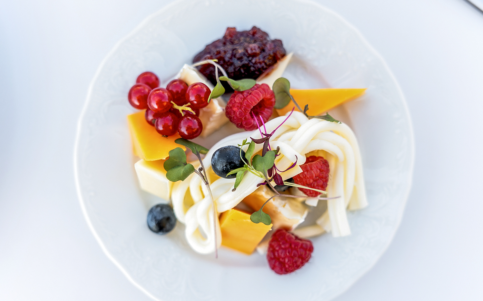 Cheese platter with berries and greens served during Sky Bar Prague Aperitivo tour.