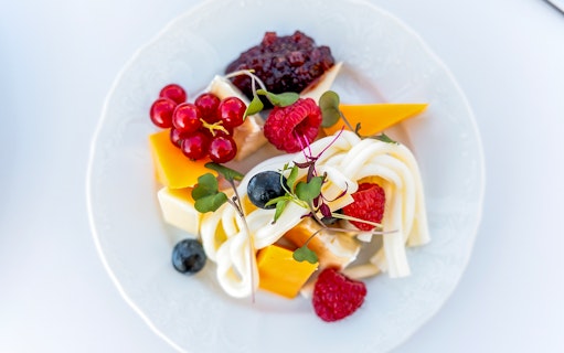 Cheese platter with berries and greens served during Sky Bar Prague Aperitivo tour.