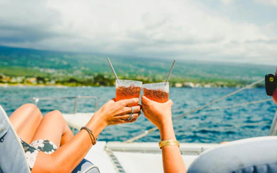 Toasting drinks on a boat during Kona Deluxe Whale Watch Sail.