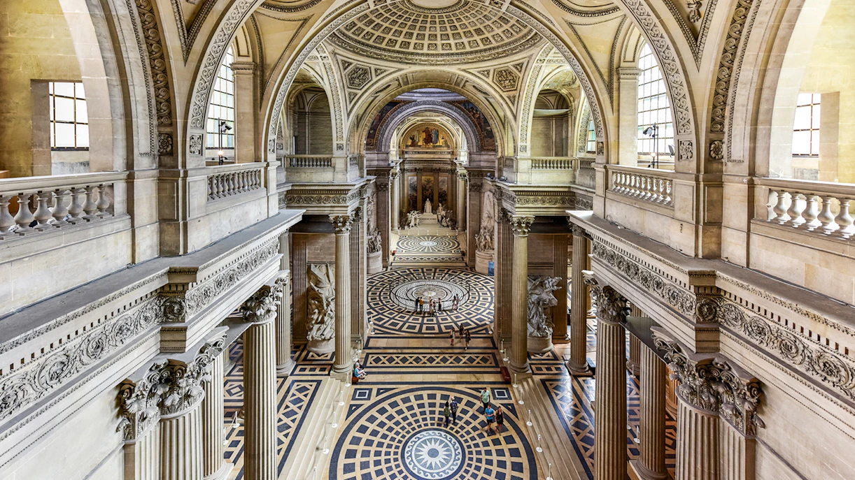 Interior view of the Pantheon in Paris showcasing its grand dome and intricate architectural details.