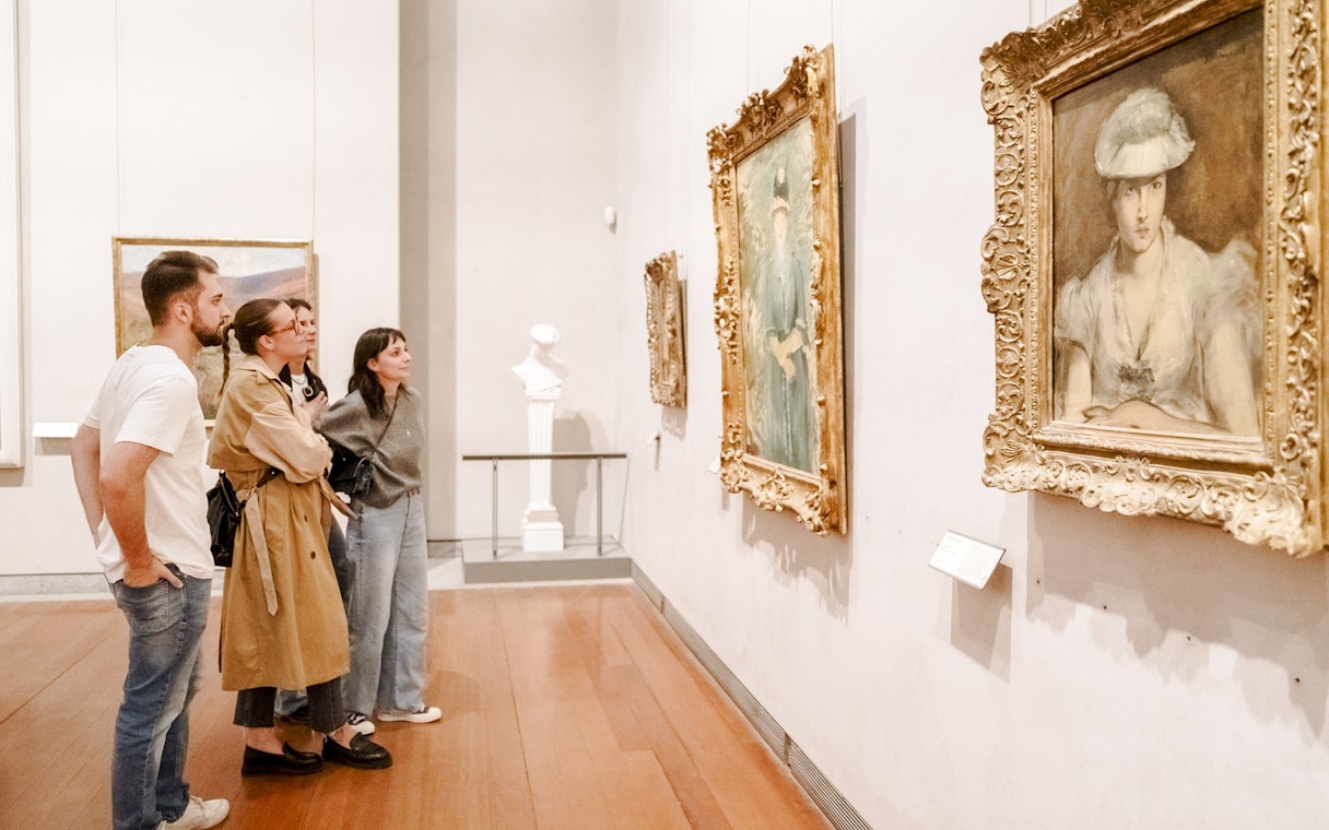 Visitors observing paintings at the Museum of Fine Arts, Lyon, France.