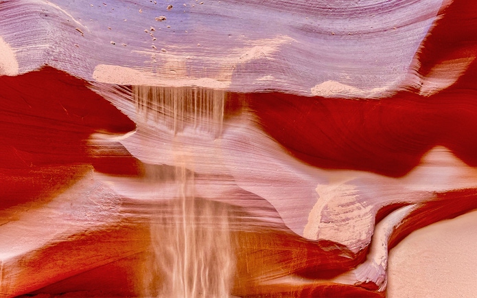 Antelope Canyon X sandstone formations with light beams in Arizona.