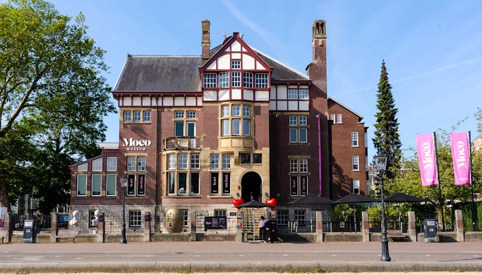 Moco Museum Amsterdam exterior with modern architecture and vibrant street art.
