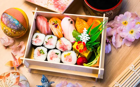 Sushi bento box with assorted nigiri and rolls, part of Tsukiji Market tour with tuna tasting.