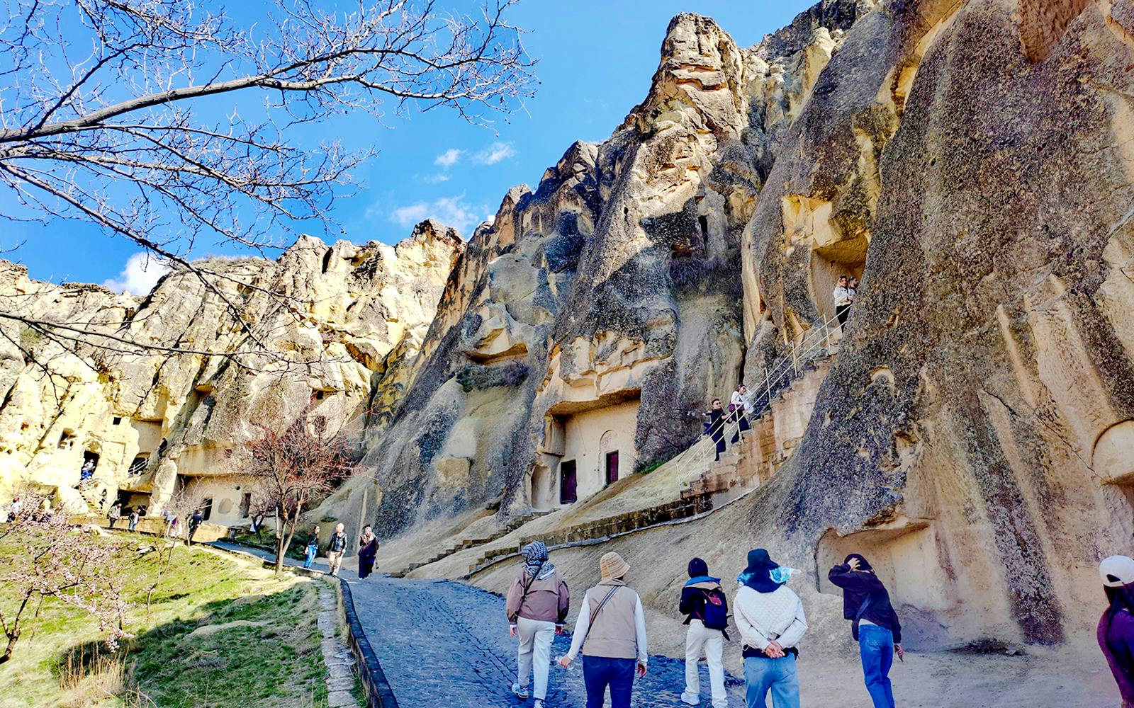 Visitors exploring rock-cut churches at Göreme Open Air Museum, Cappadocia.