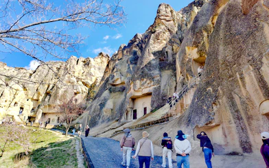 Visitors exploring rock-cut churches at Göreme Open Air Museum, Cappadocia.